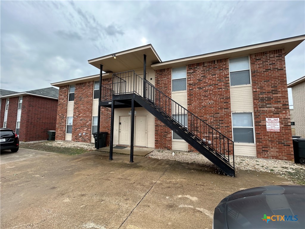 a view of a house with stairs and a street