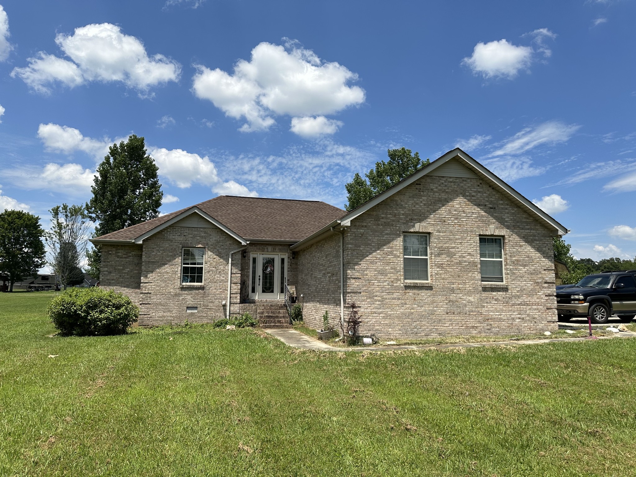 a front view of house with yard and green space