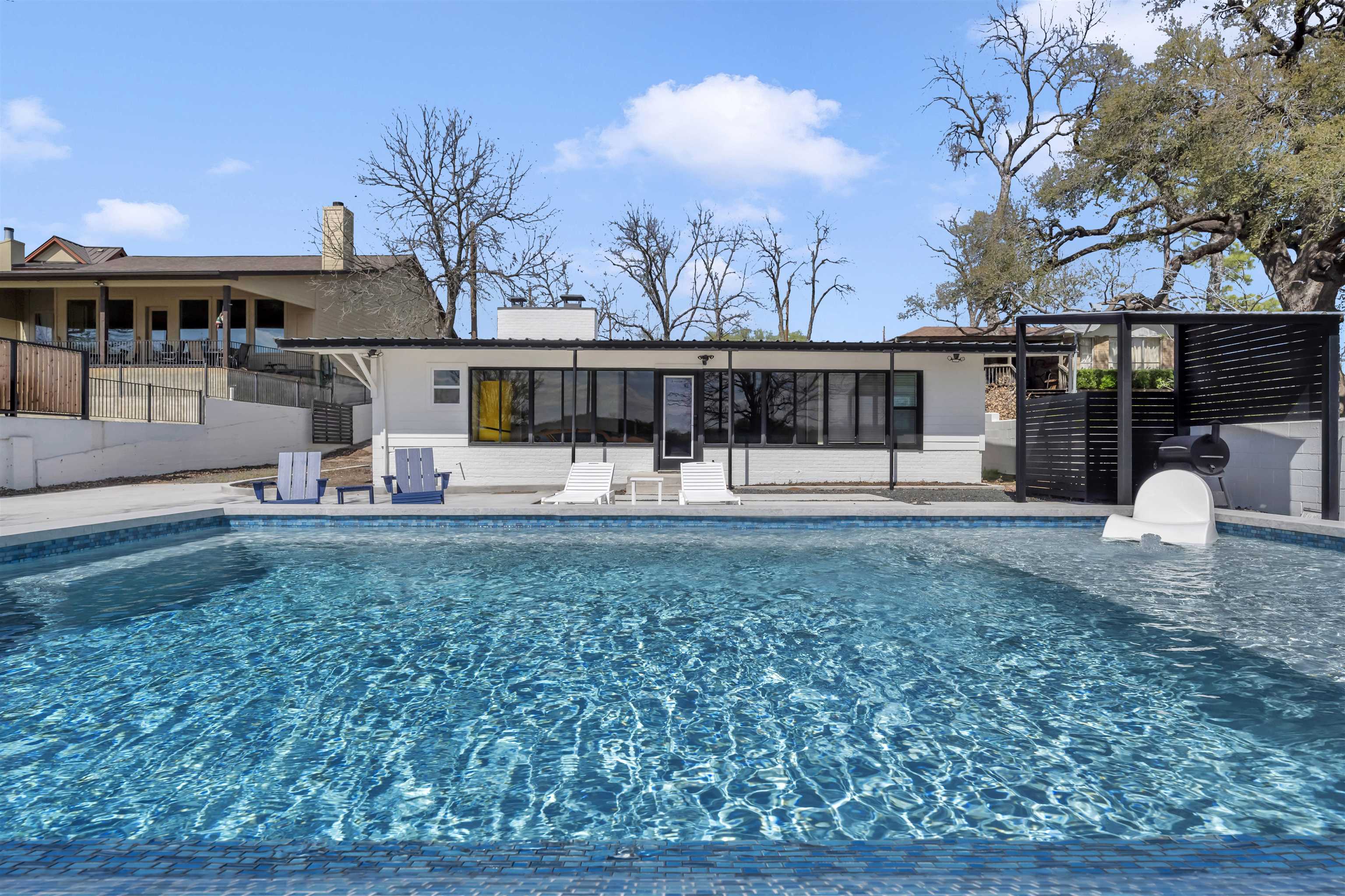 a view of a house with backyard and sitting area