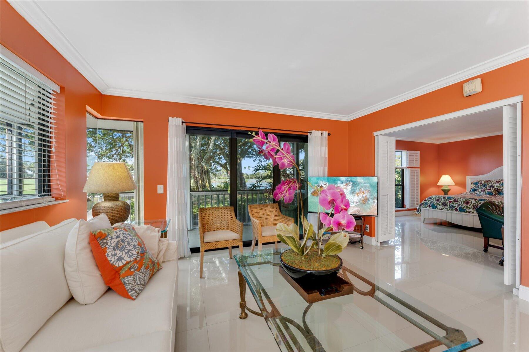 a living room with furniture and a floor to ceiling window