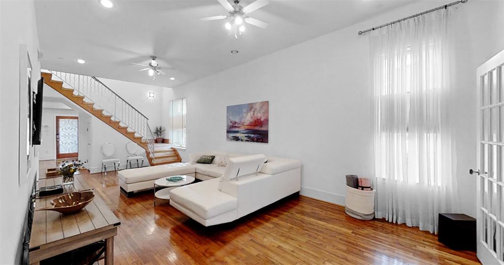 a living room with furniture and a chandelier