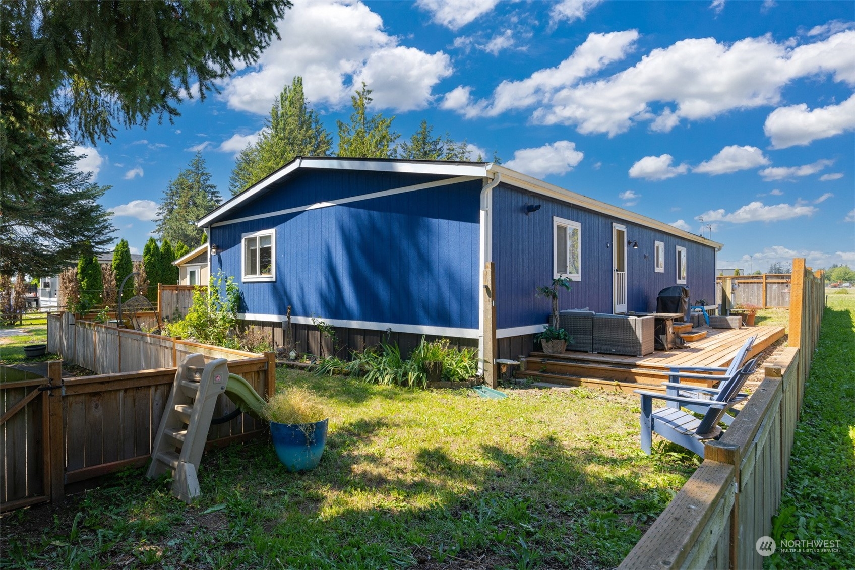 a view of backyard with swimming pool outdoor seating