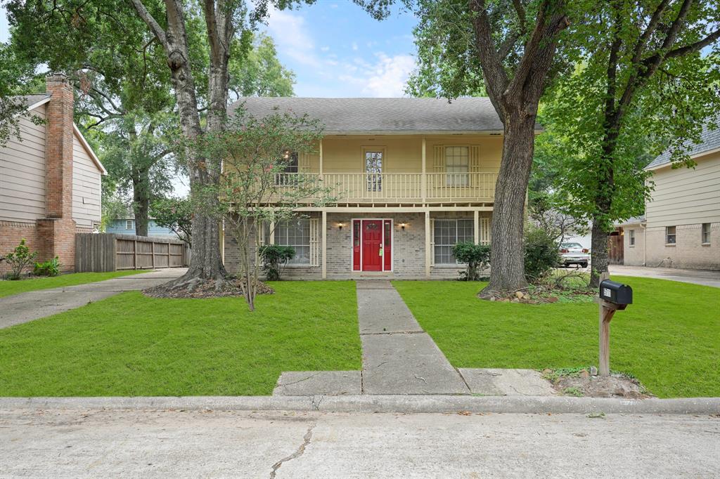 a view of a brick house with a yard