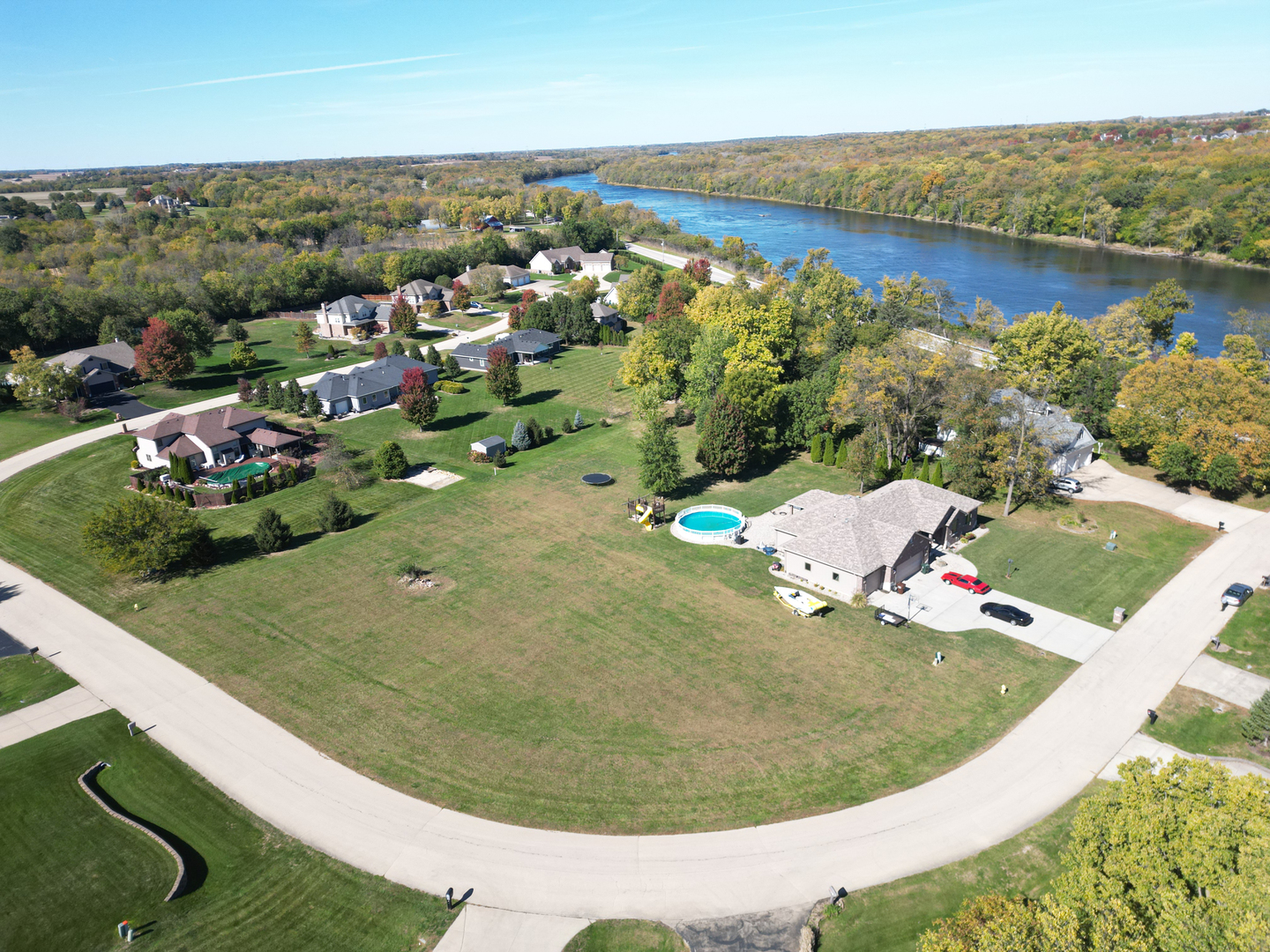 an aerial view of a house with a garden and lake view