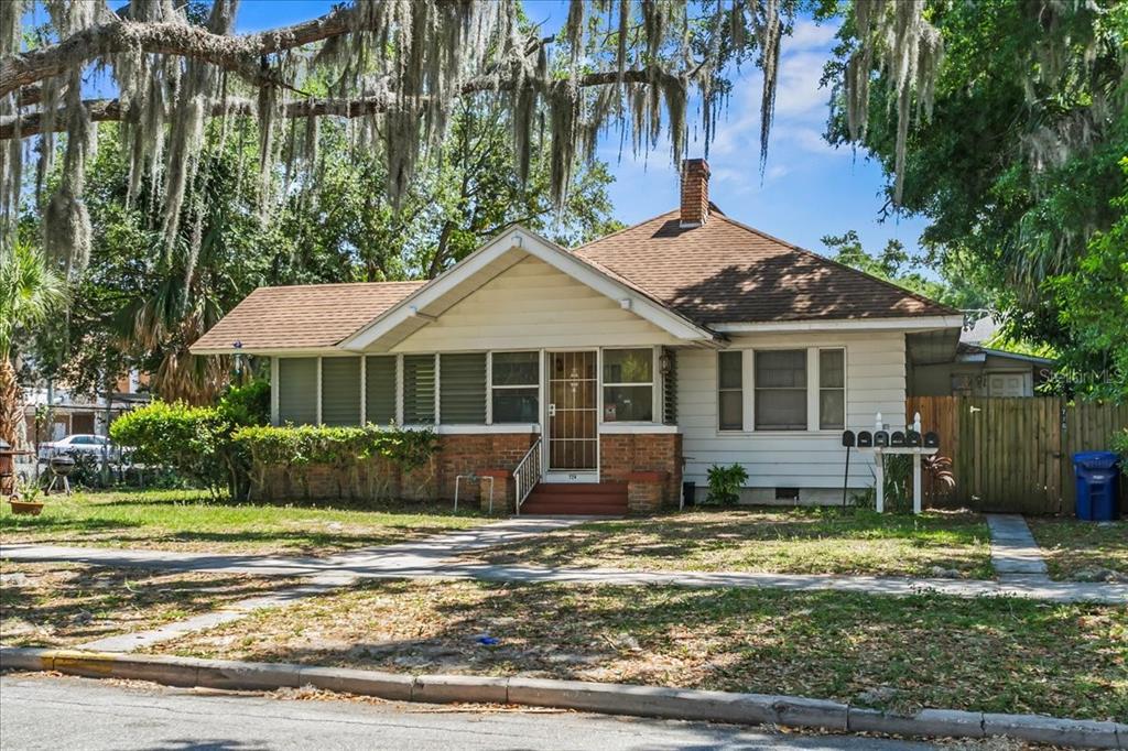 a front view of a house with a garden and yard