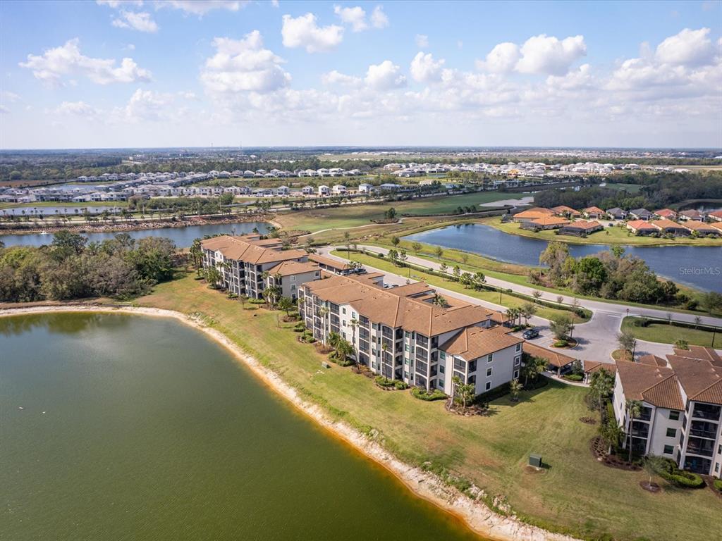 an aerial view of residential houses with lake view