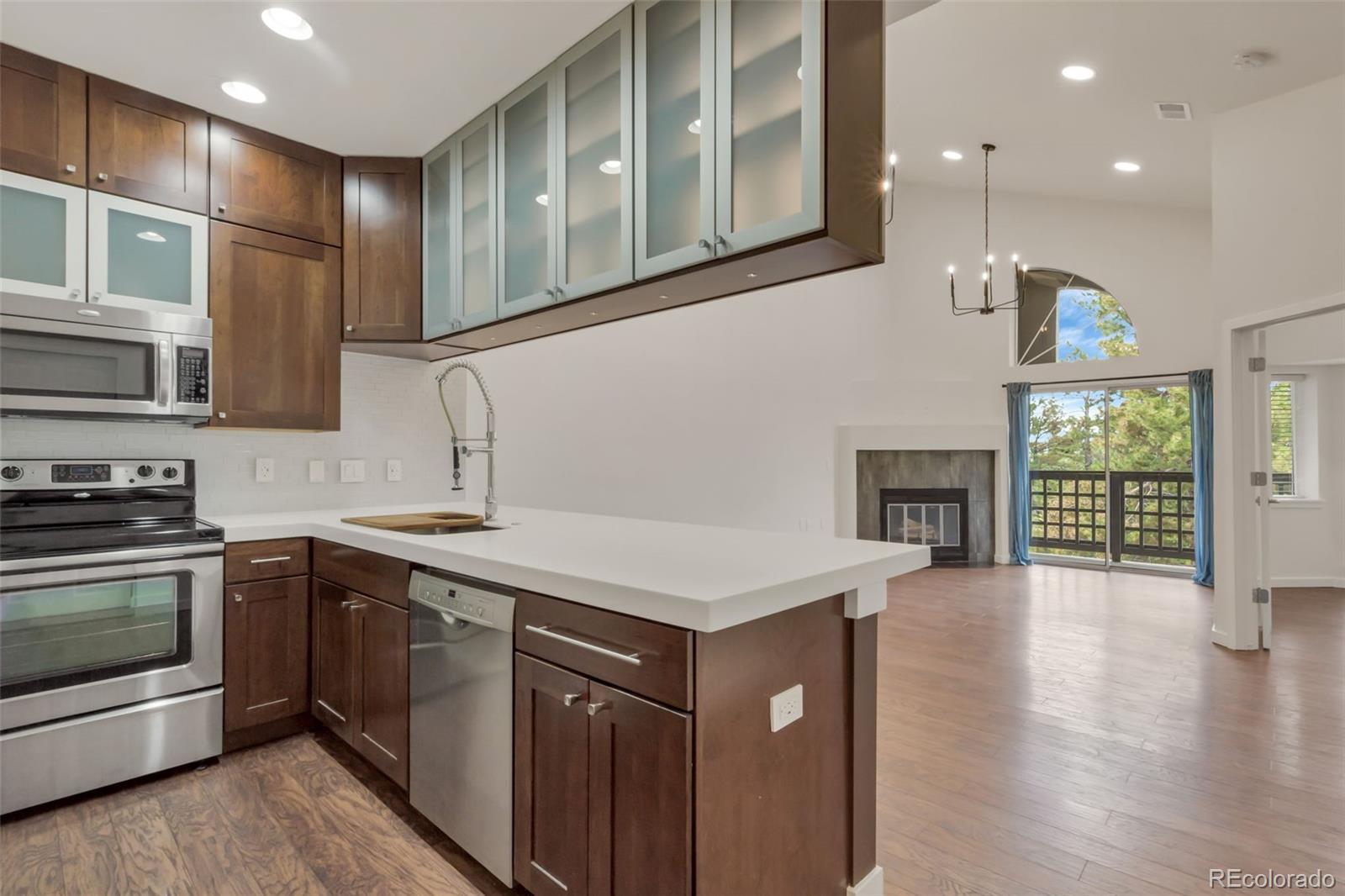 a kitchen that has a sink a stove and cabinets