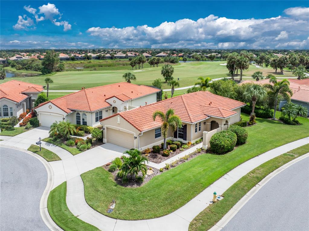 an aerial view of a house with garden space lake view and mountain view