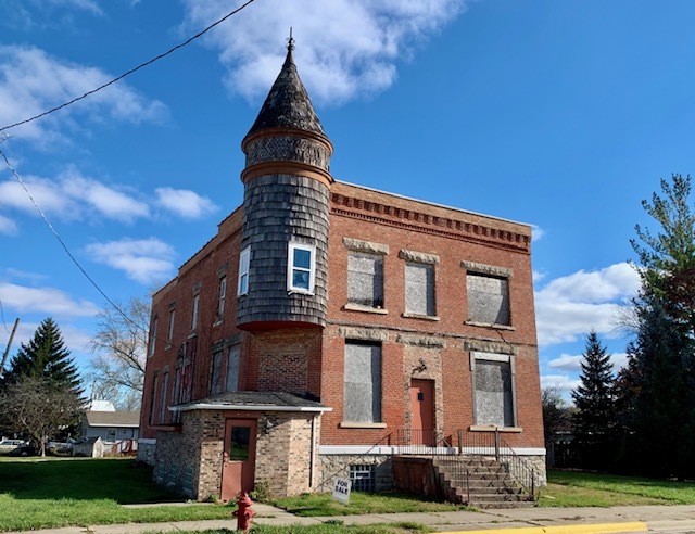 a view of a brick building next to a yard