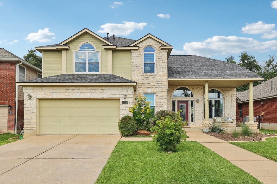 a front view of a house with a yard and garage