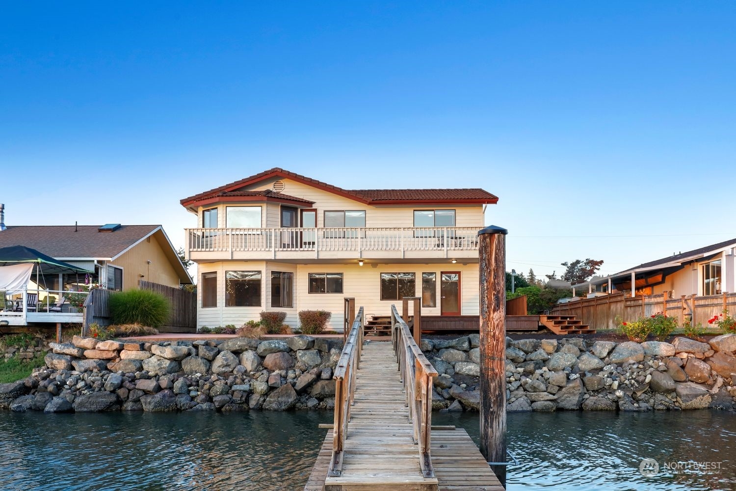 a front view of a house with a lake view