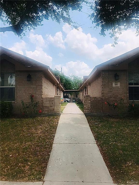 View of side of property featuring a lawn