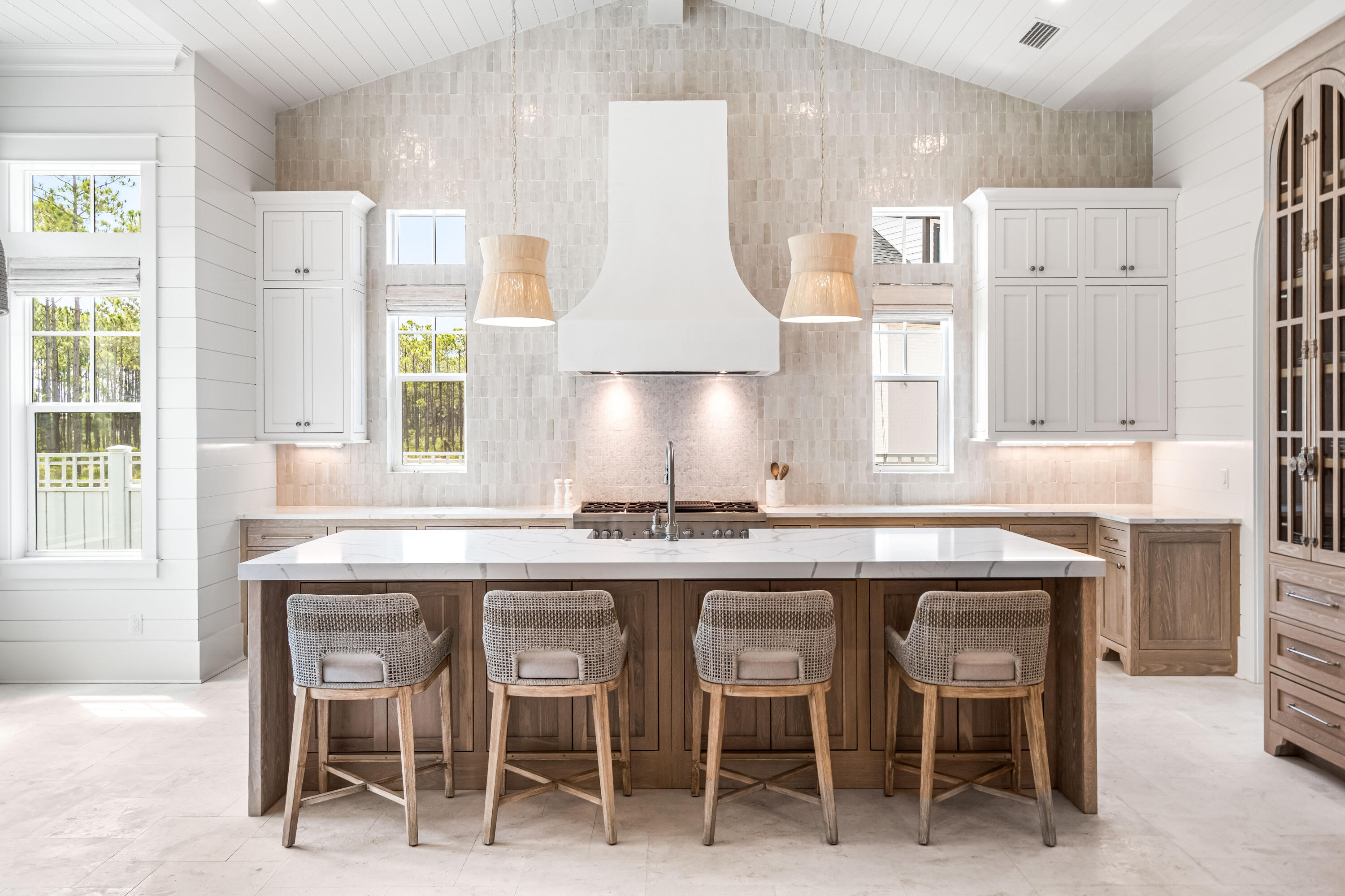 a kitchen with cabinets and chairs