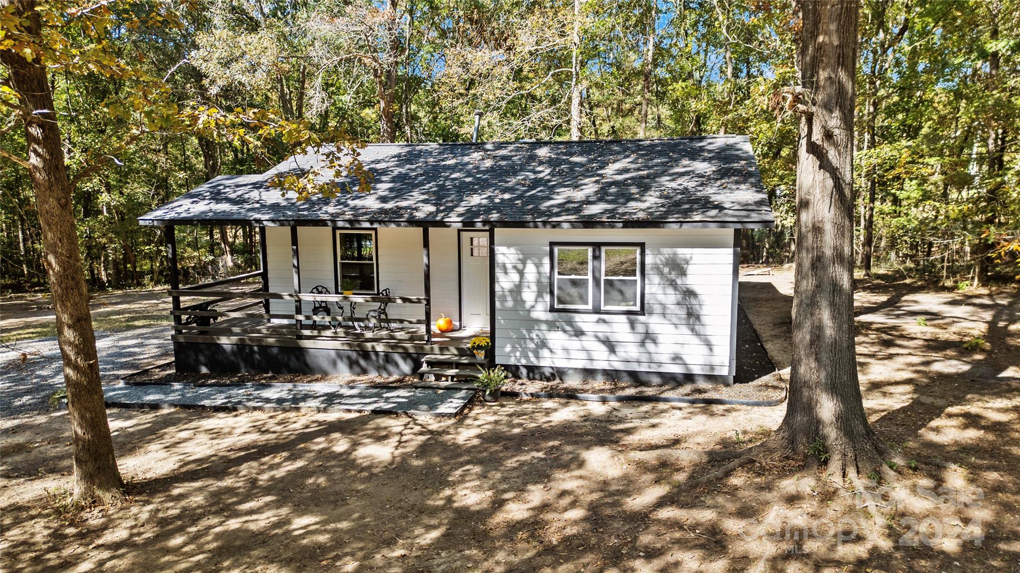 a view of a house with a tree in the background