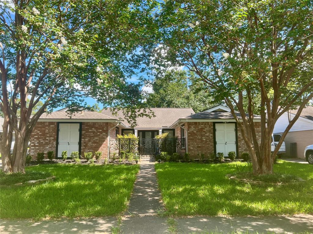 front view of a house with a tree