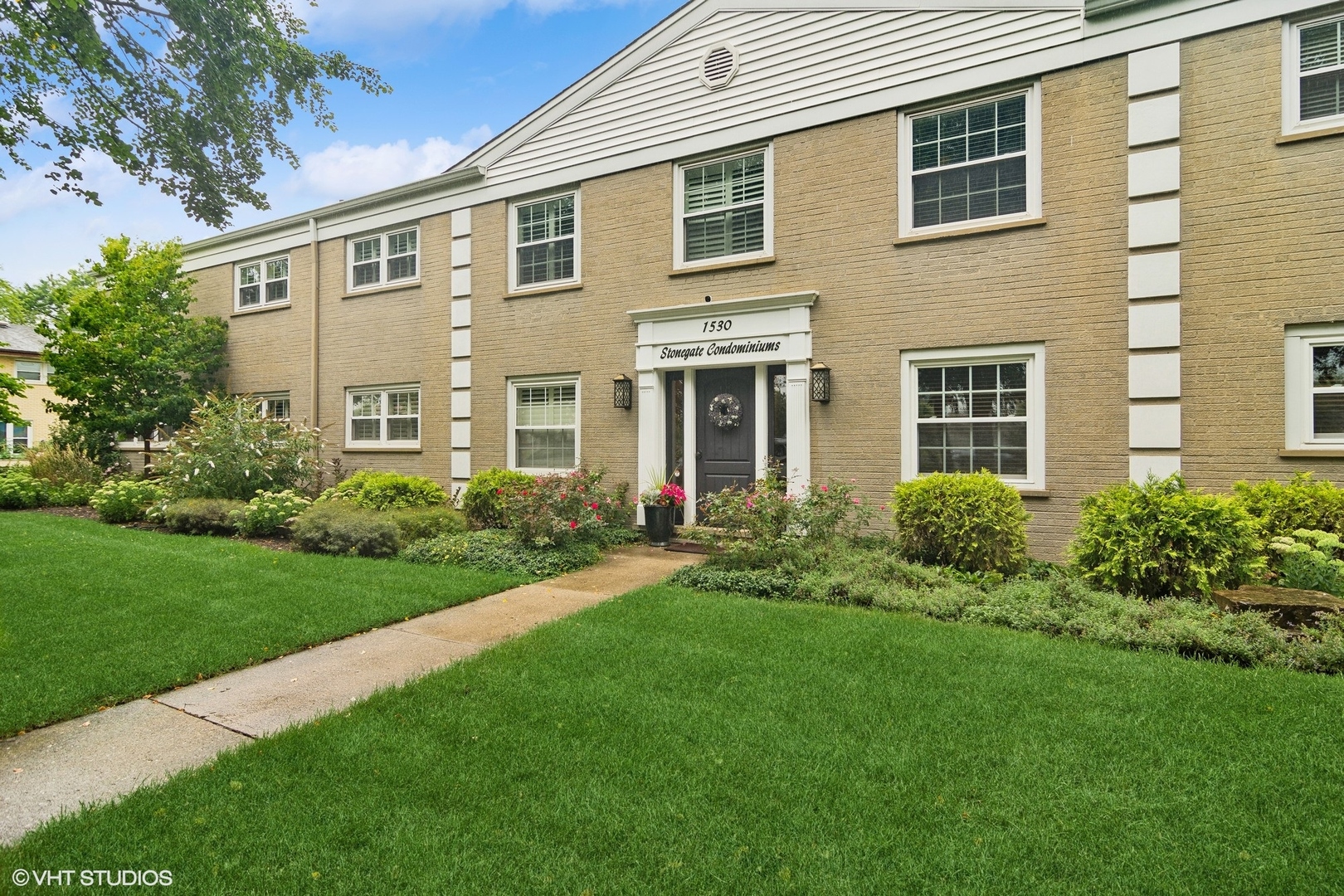 a front view of a house with garden and porch