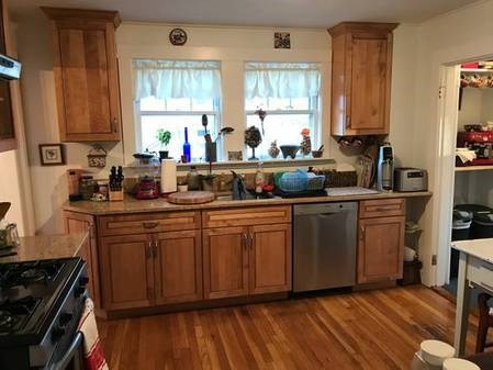 a kitchen with sink a window and cabinets