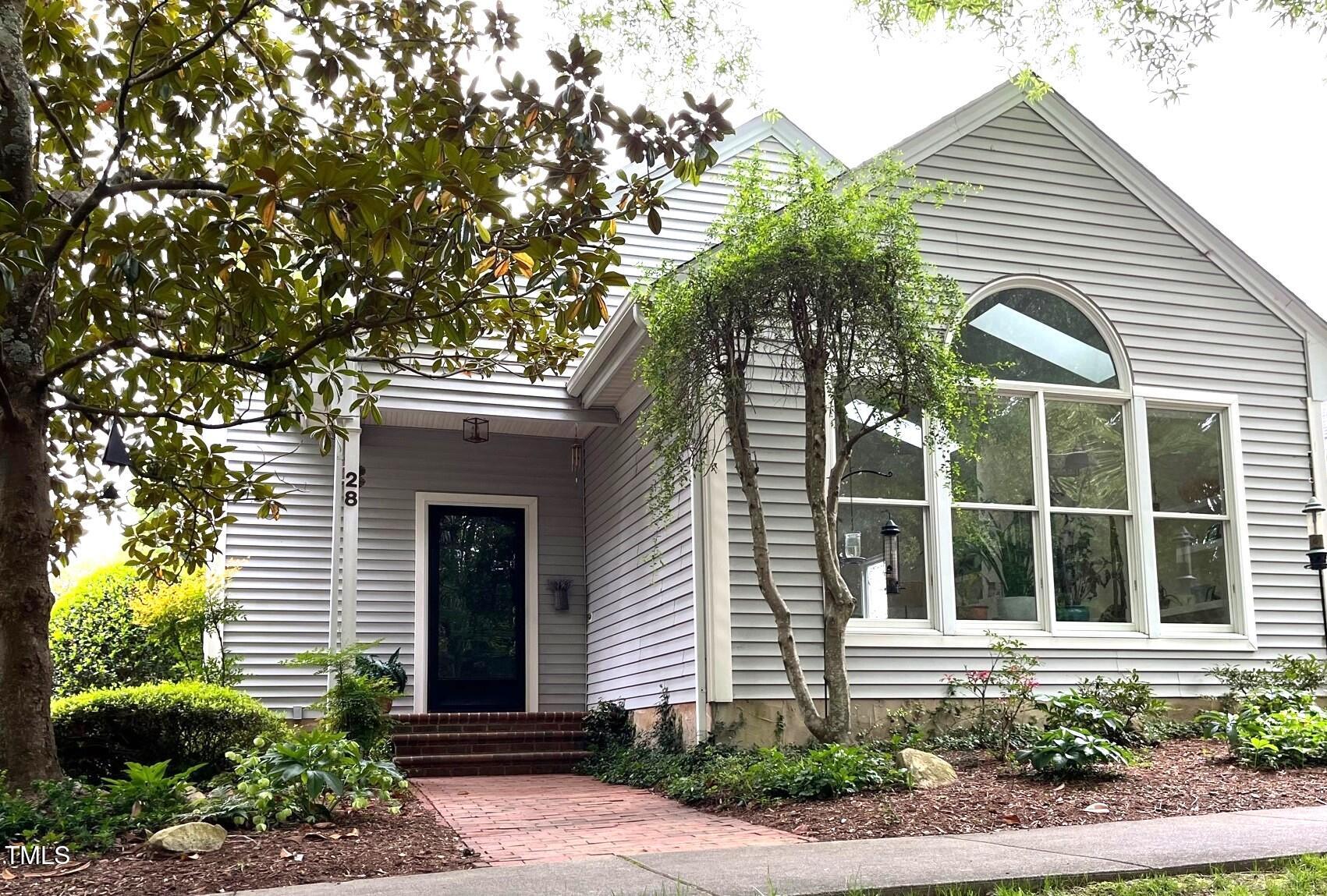 a house with a tree in front of it