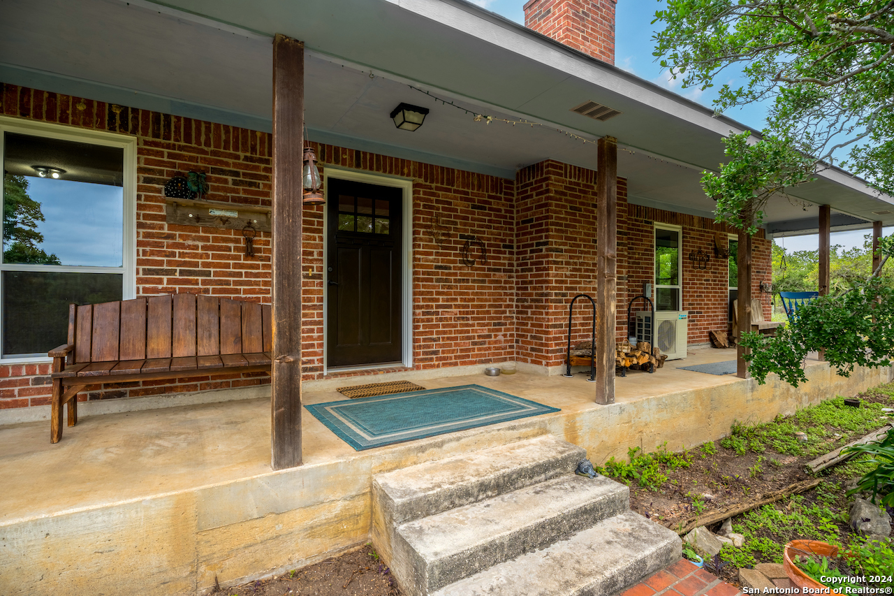 a view of a house with backyard and porch