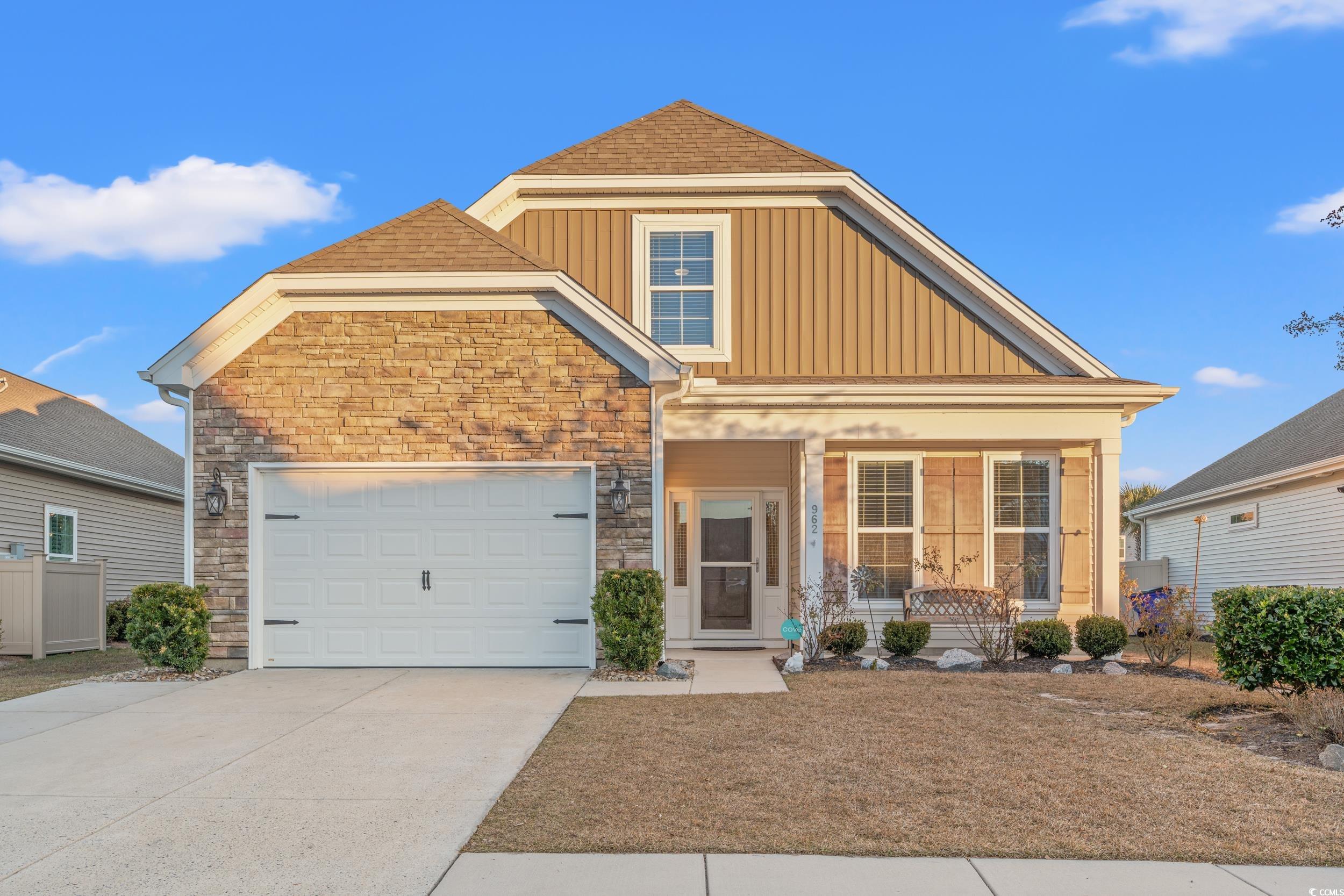 Craftsman-style house featuring a porch and a gara