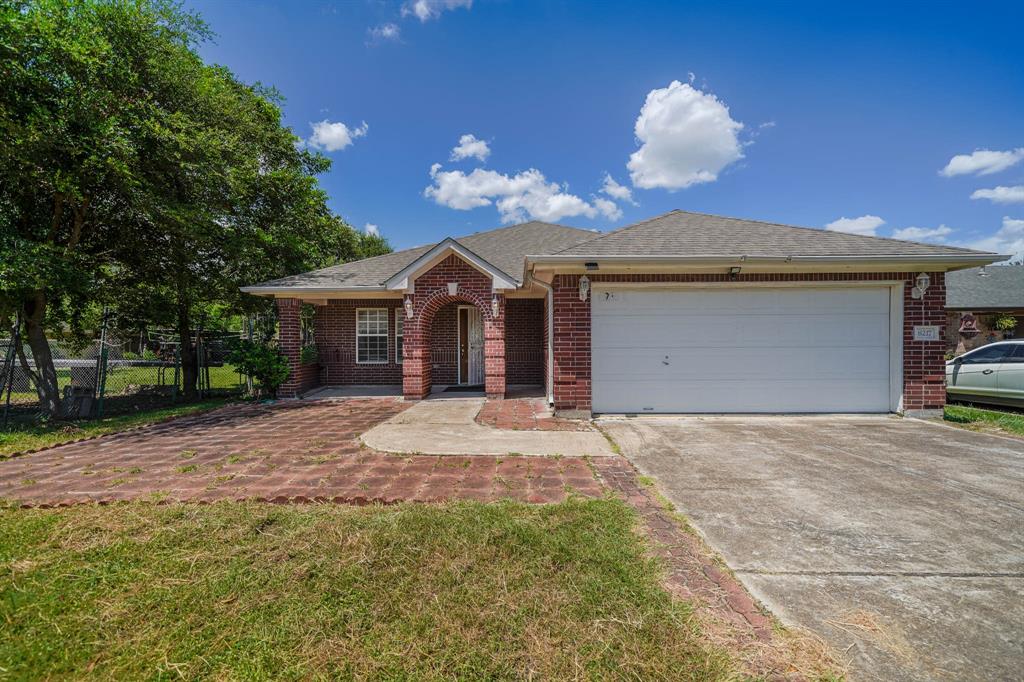 a front view of a house with a yard and a garage