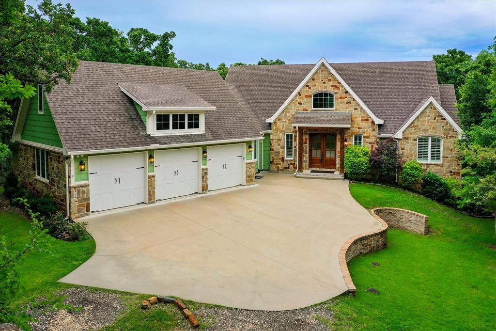 a view of a house with a yard and garage