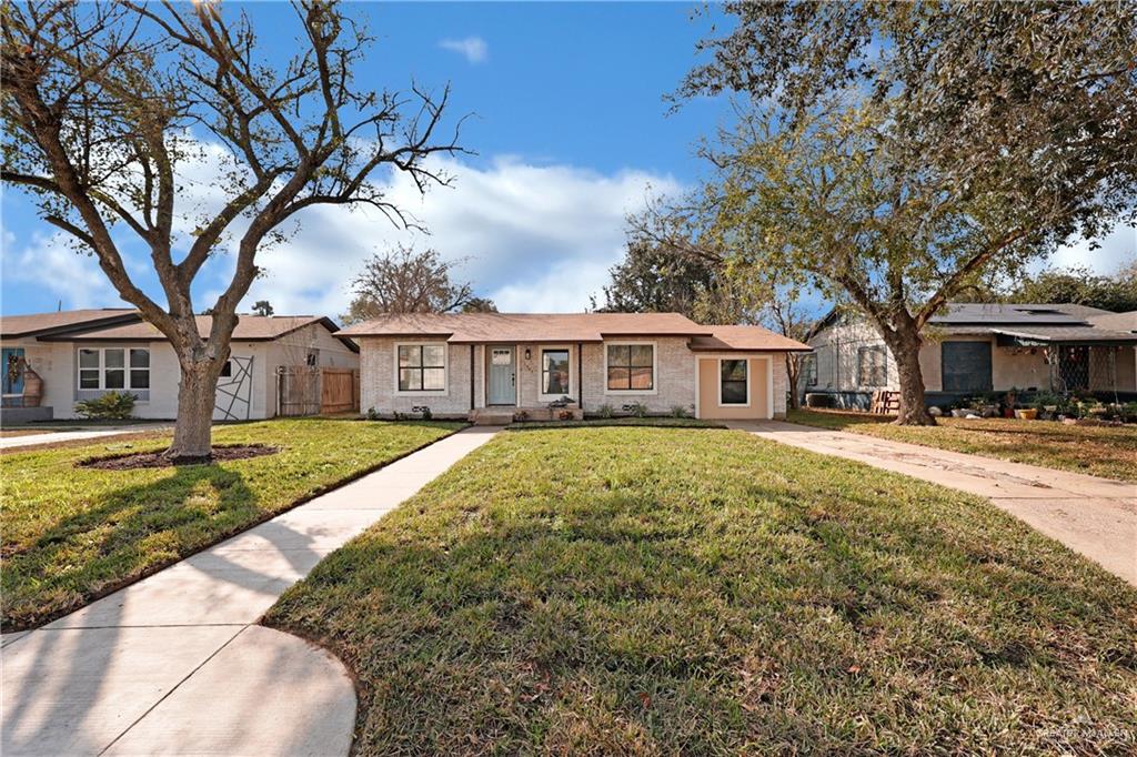 Ranch-style home featuring a front lawn