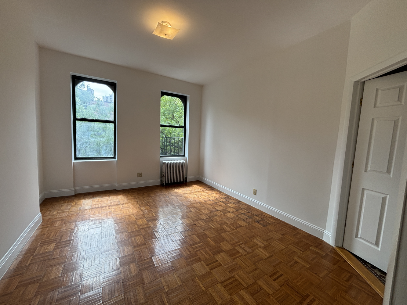 an empty room with windows and closet