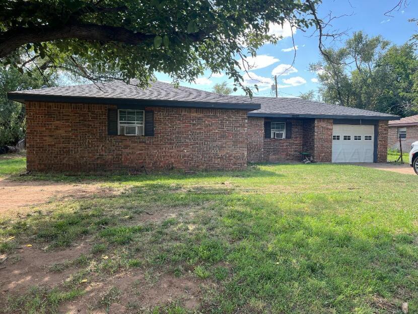 a brick house with a tree in front of it