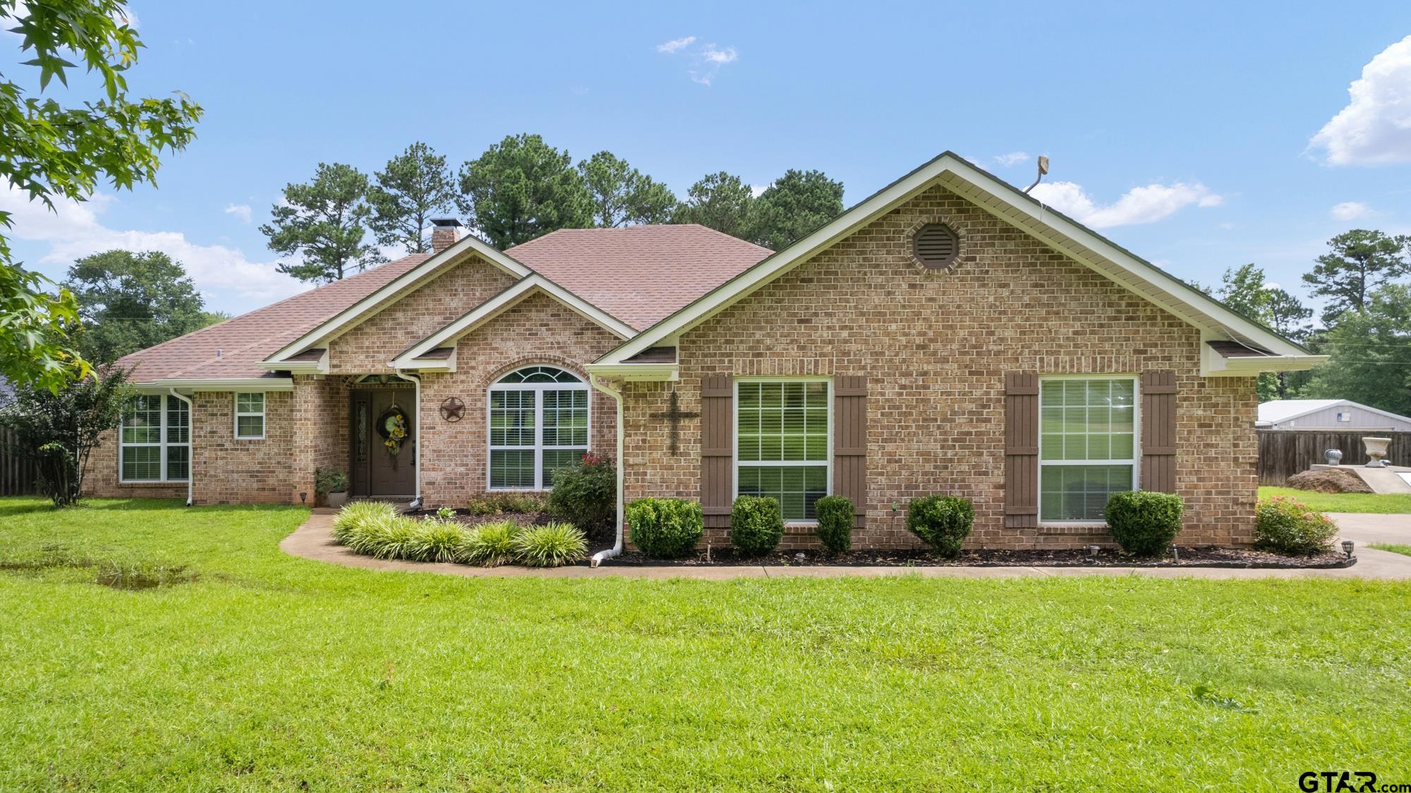 a front view of house with yard and green space