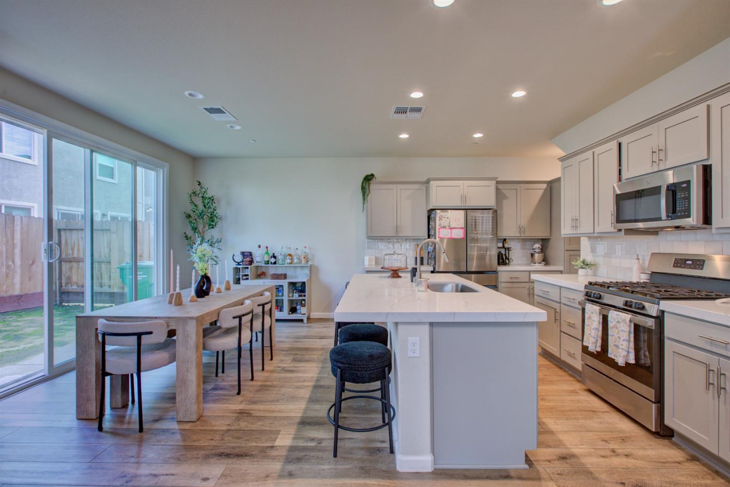 a large kitchen with kitchen island a large island in the center