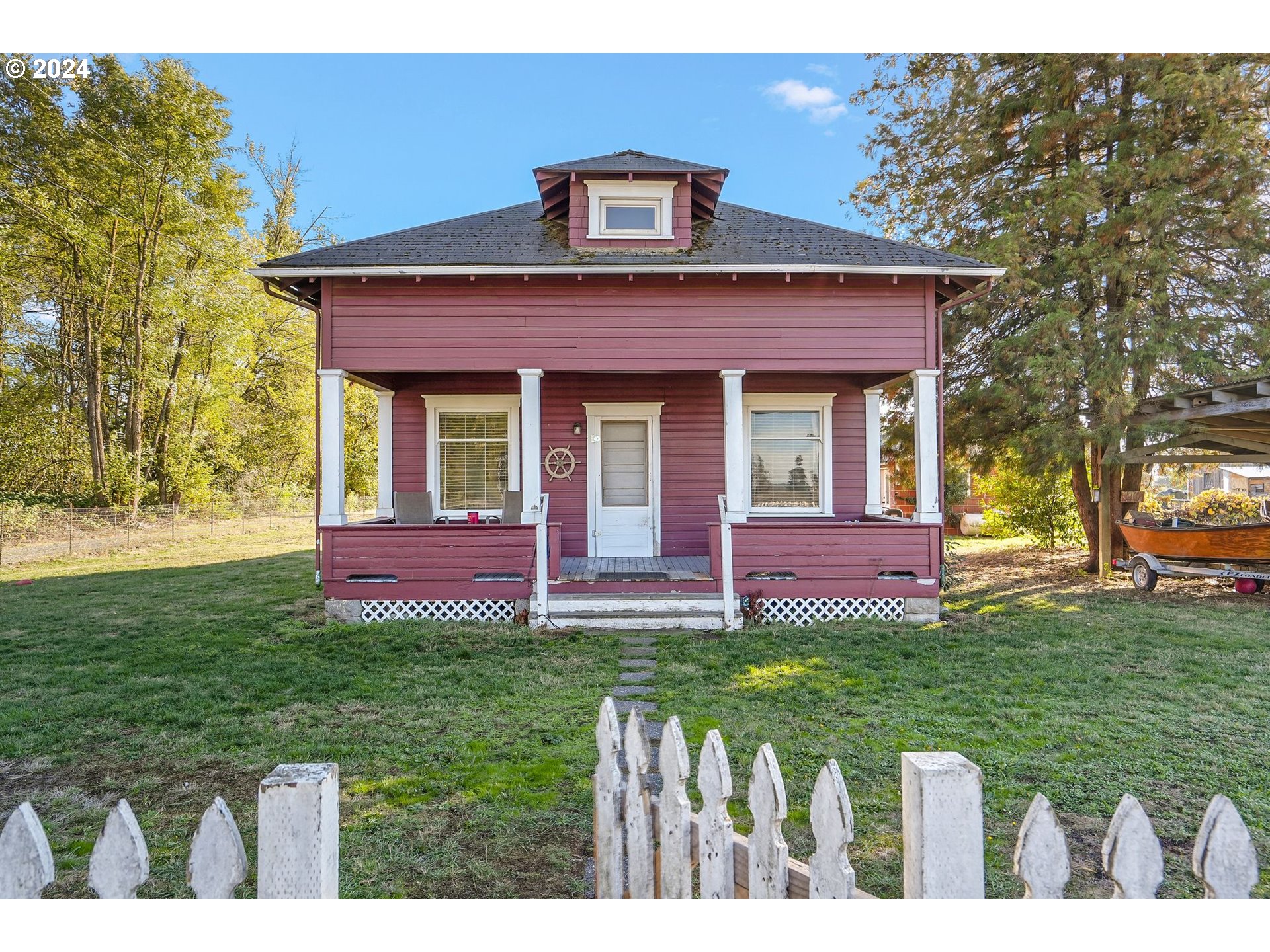 a front view of a house with a garden