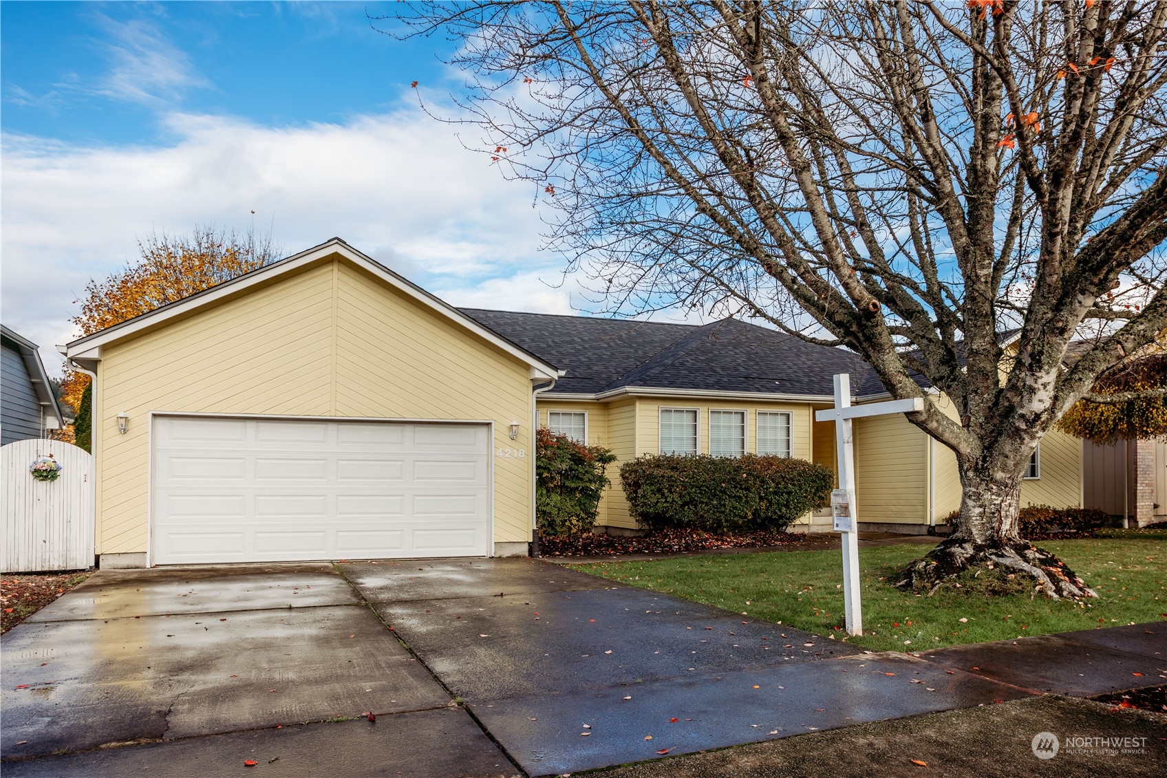 a view of a house with a yard and garage