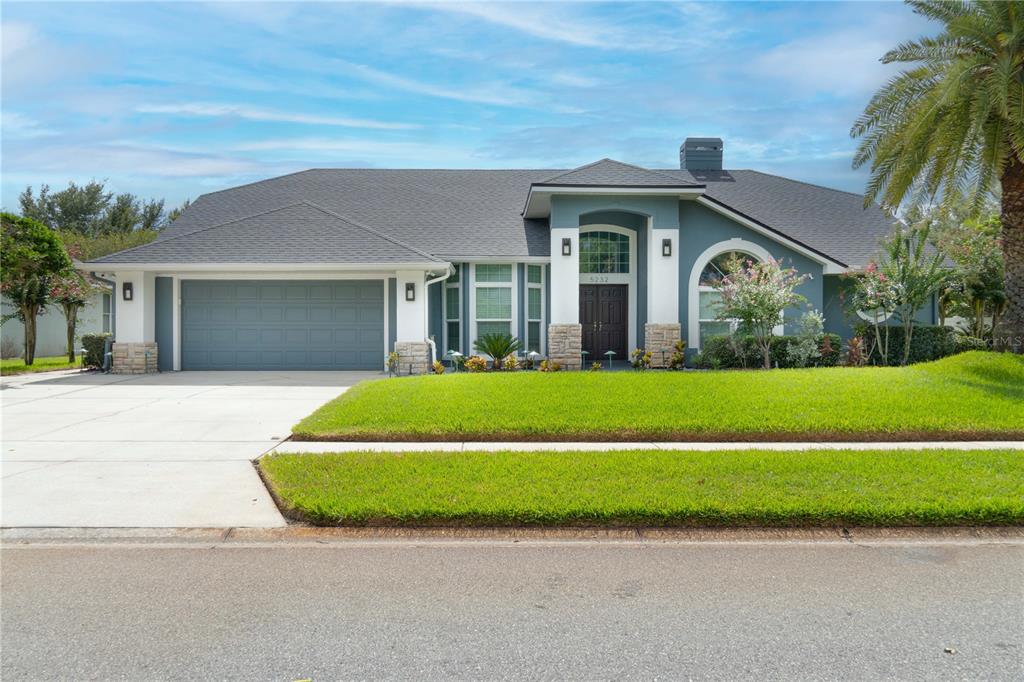 a front view of house with yard and green space