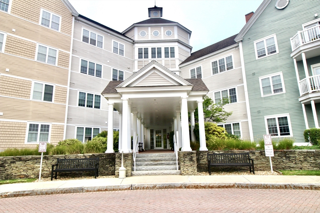 a front view of a residential apartment building with a yard