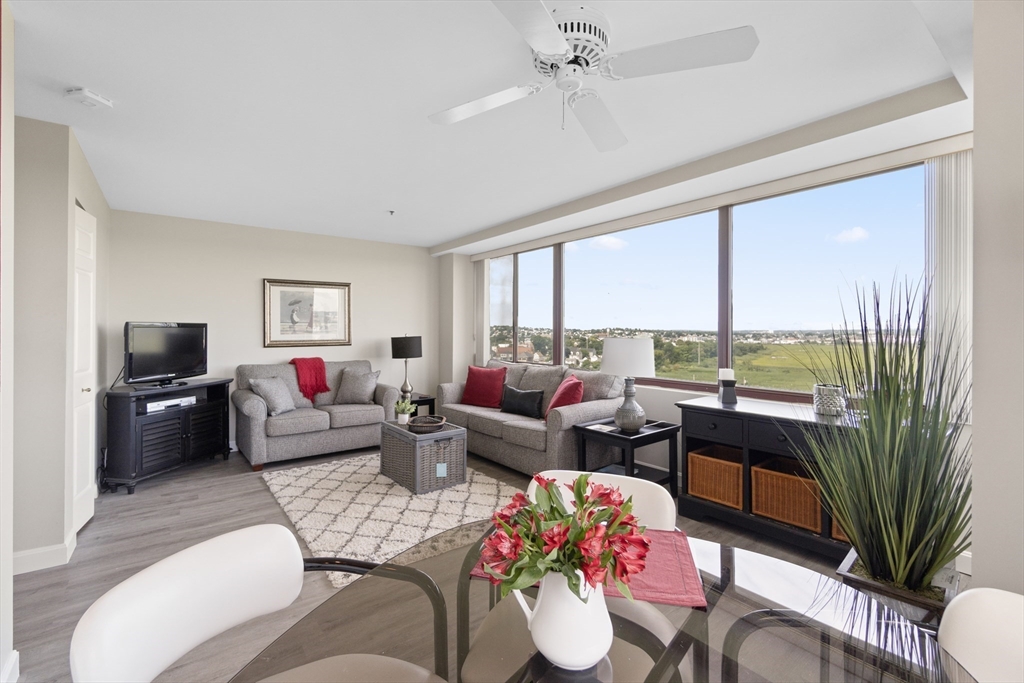 a living room with furniture and a floor to ceiling window