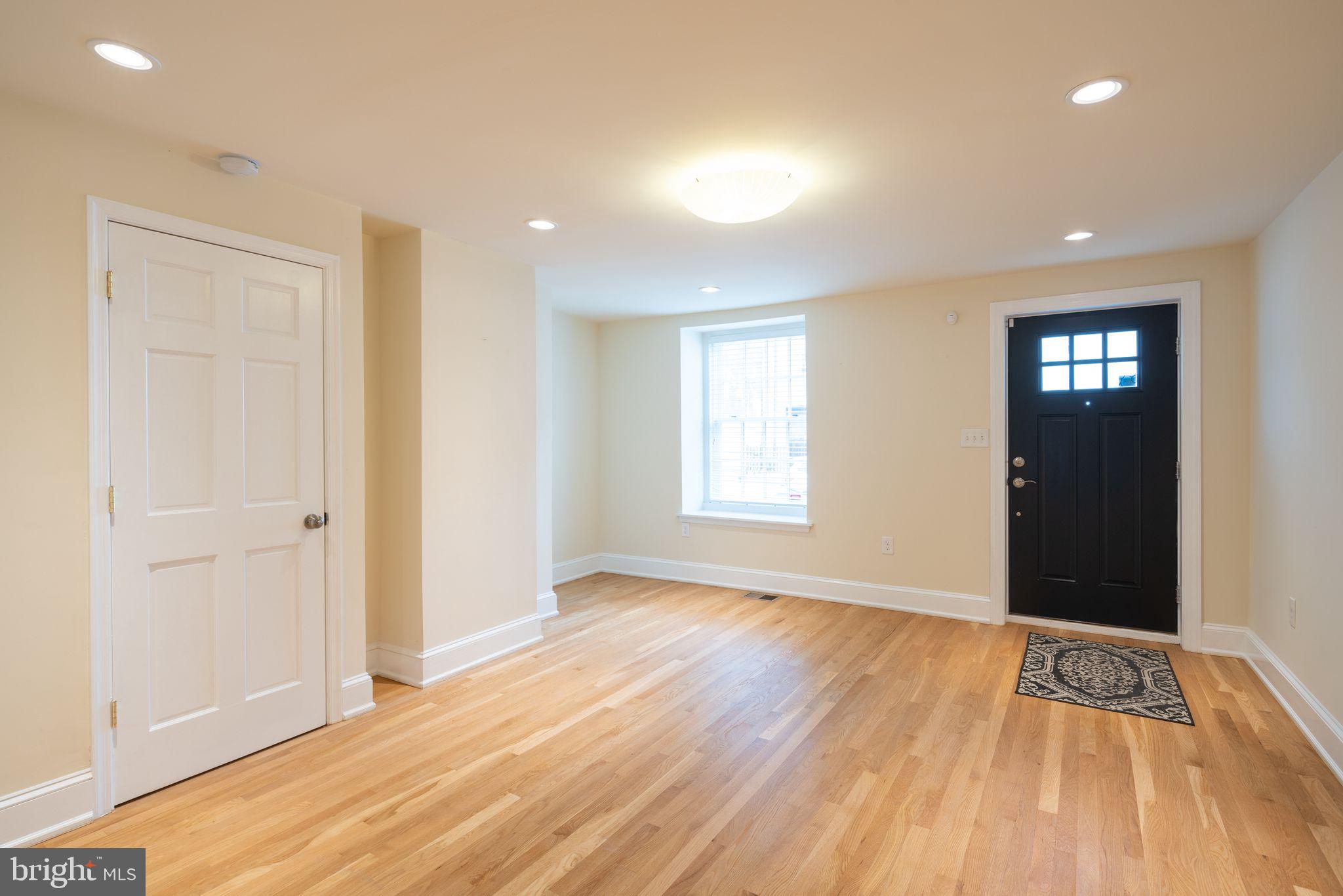 wooden floor in an empty room with a window