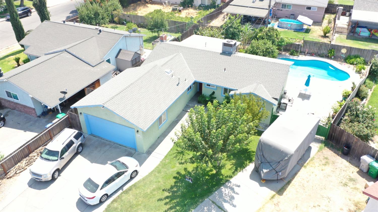 an aerial view of a house with a swimming pool