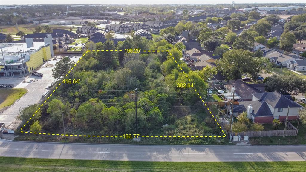 an aerial view of residential houses with outdoor space and yard