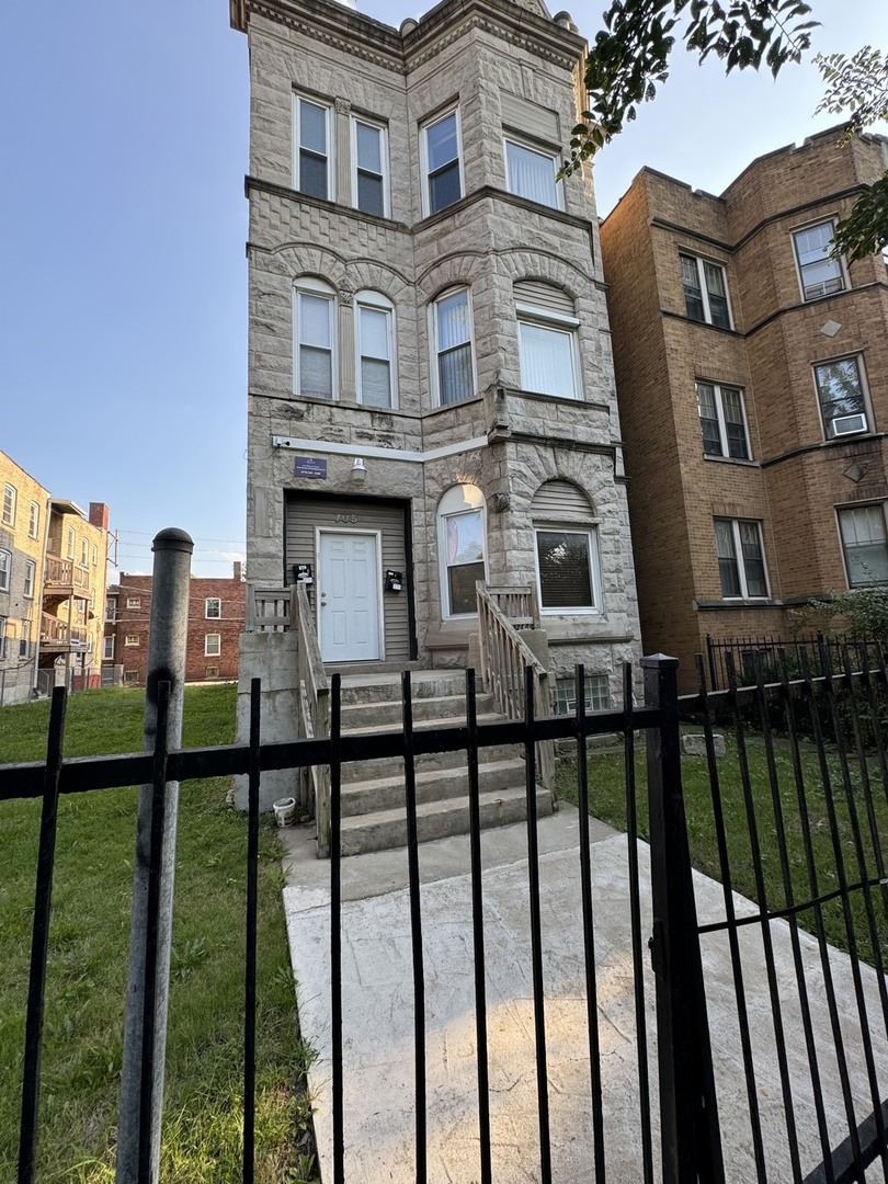 a view of a brick building next to a yard