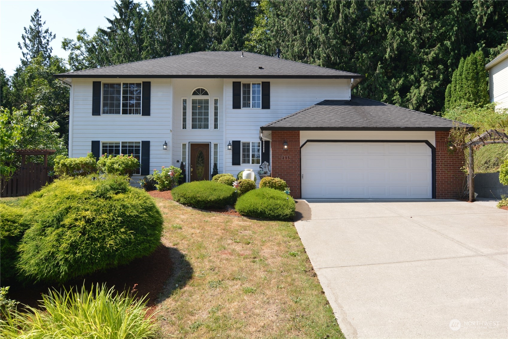 a front view of a house with a garden