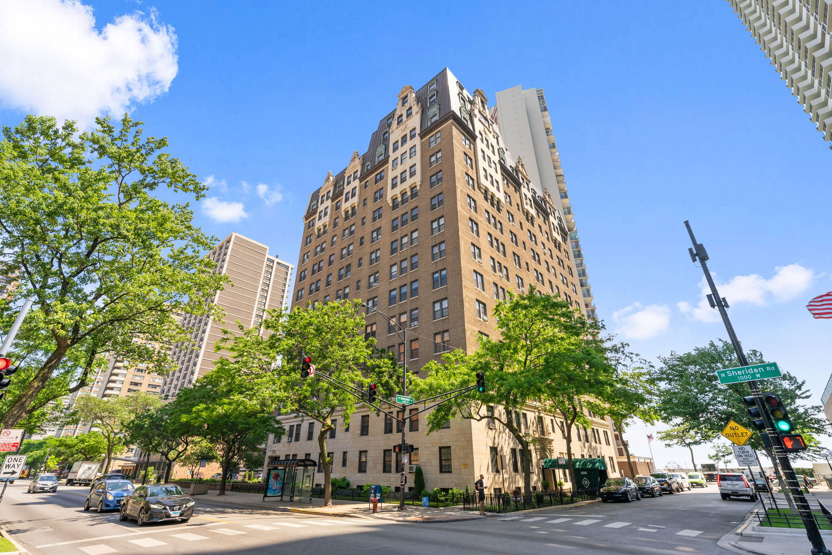 a view of a tall building next to a road