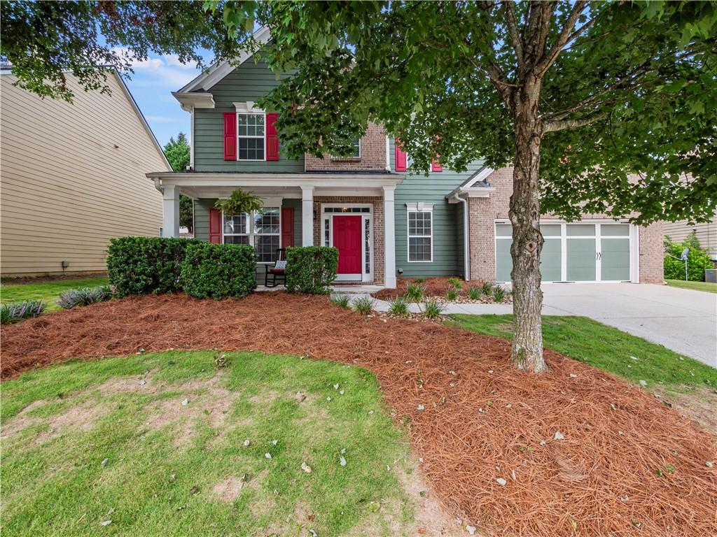 a house that has a tree in front of the house