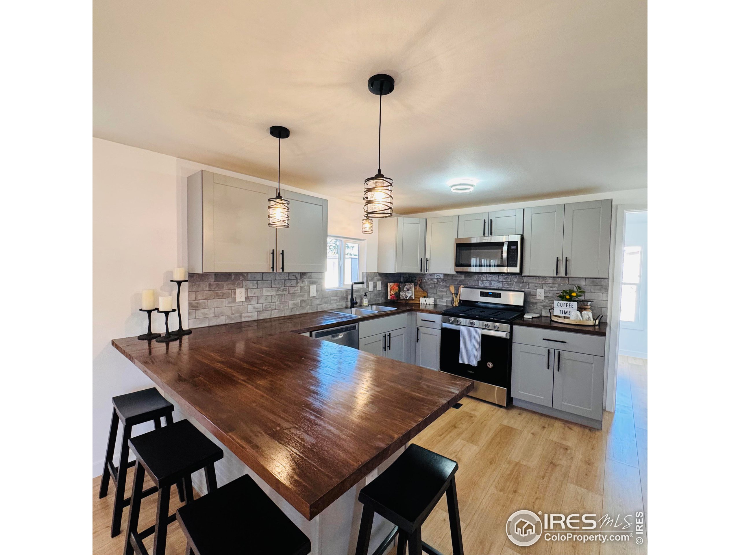 a kitchen with kitchen island a sink counter and chairs