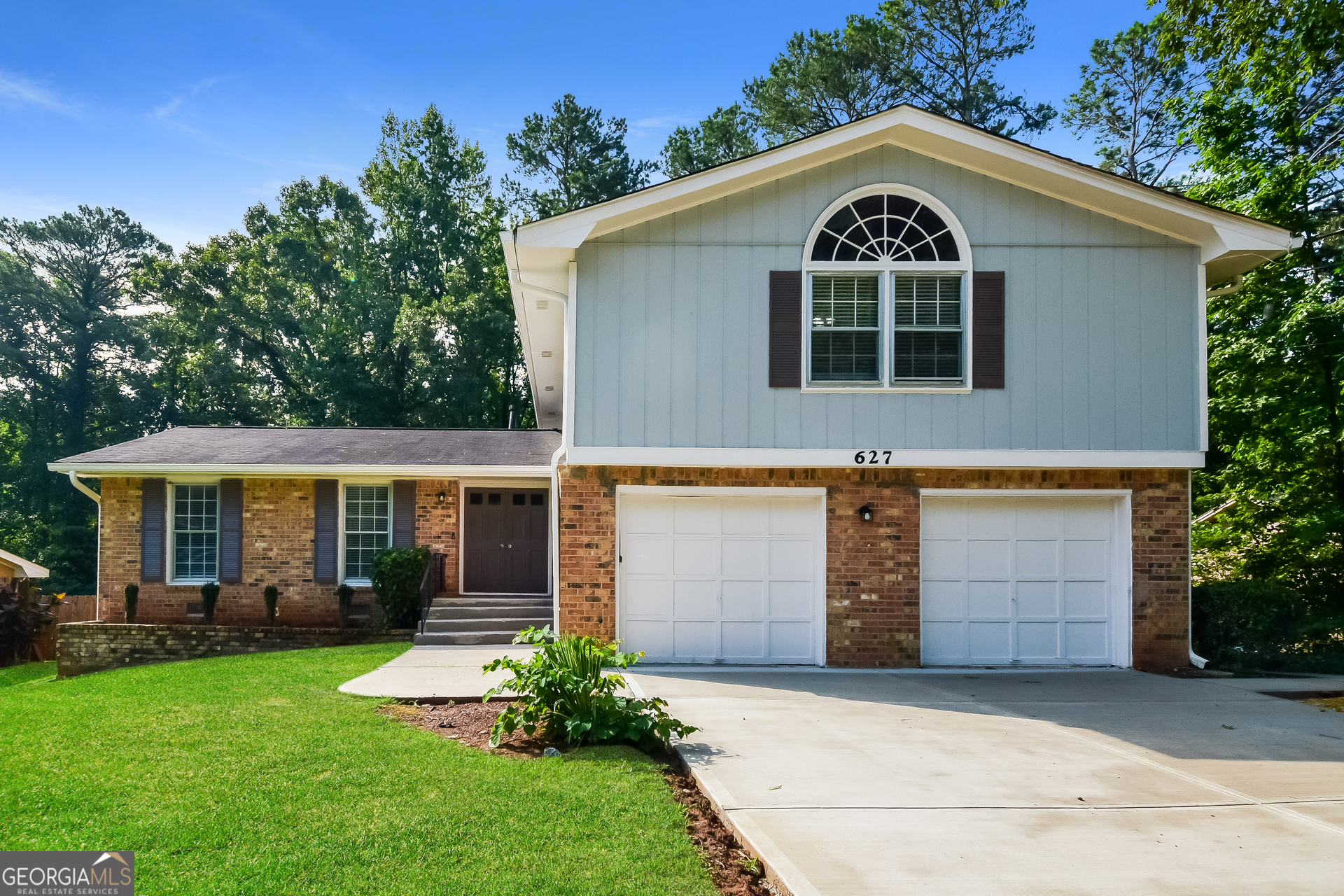 a front view of a house with a yard and garage