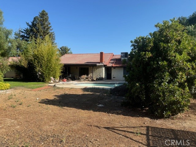 a front view of a house with yard and tree