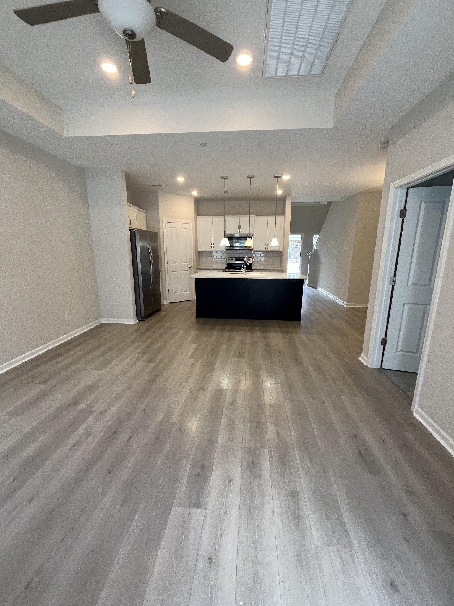 a view of a room with furniture and wooden floor