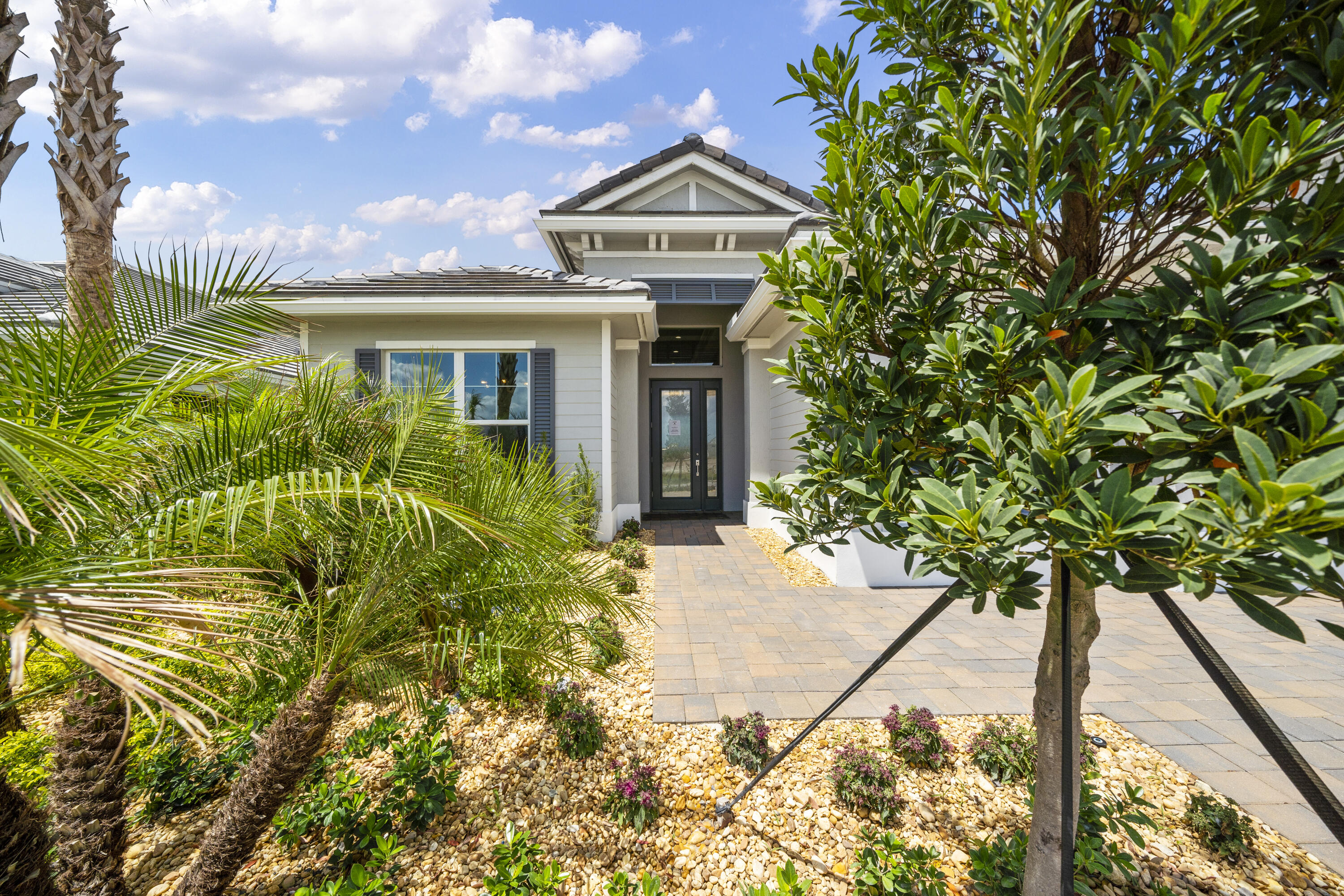 a front view of a house with a garden