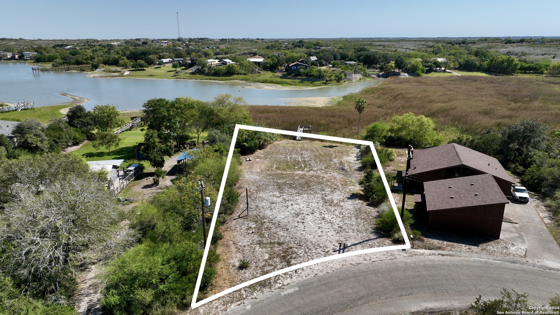 an aerial view of a house with lake view