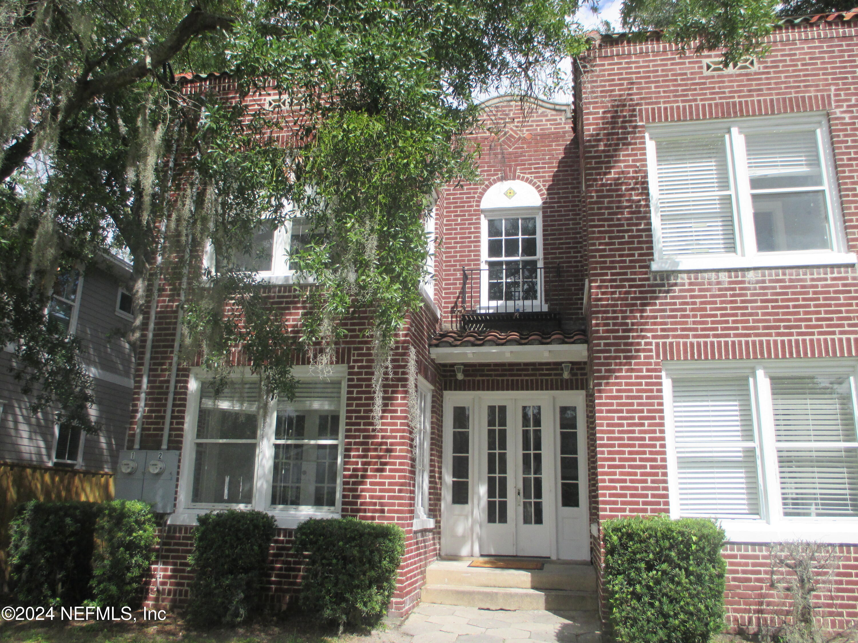 a view of a brick house with a large windows